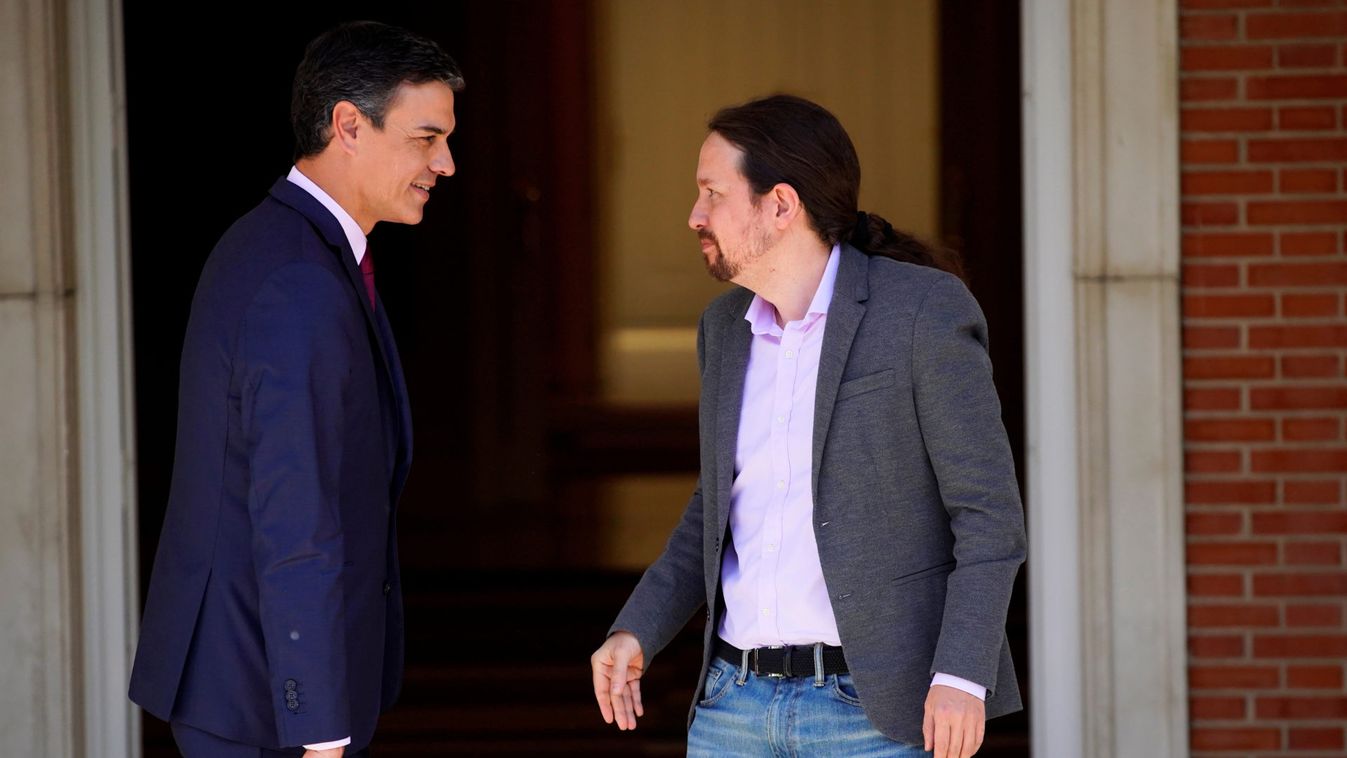 Spain's acting Prime Minister Pedro Sanchez greets Unidas Podemos' (Together We Can) leader Pablo Iglesias at the Moncloa Palace in Madrid