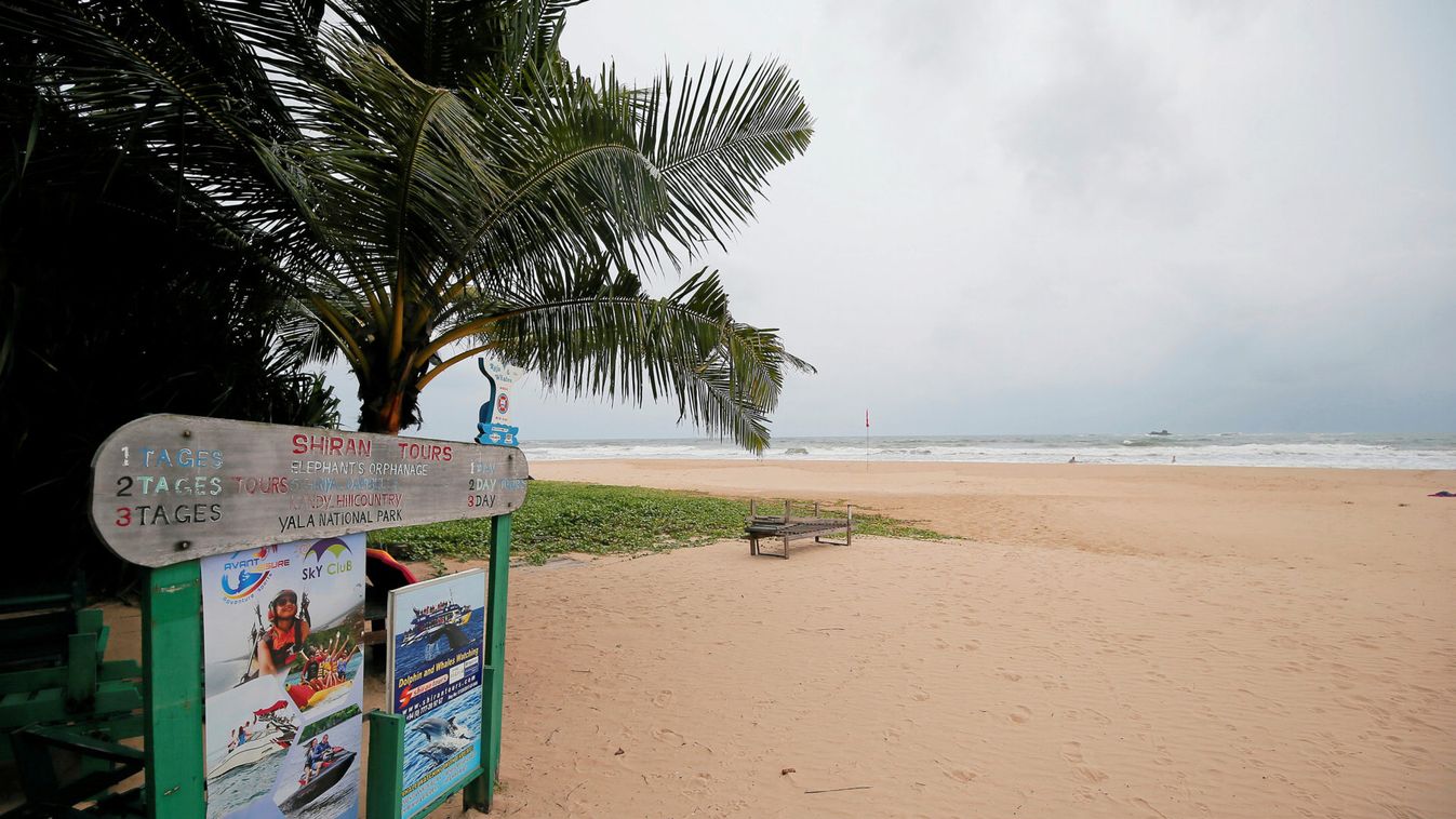 An empty beach is seen near a sign of the boat safari and whale watching center in a tourist area in Bentota