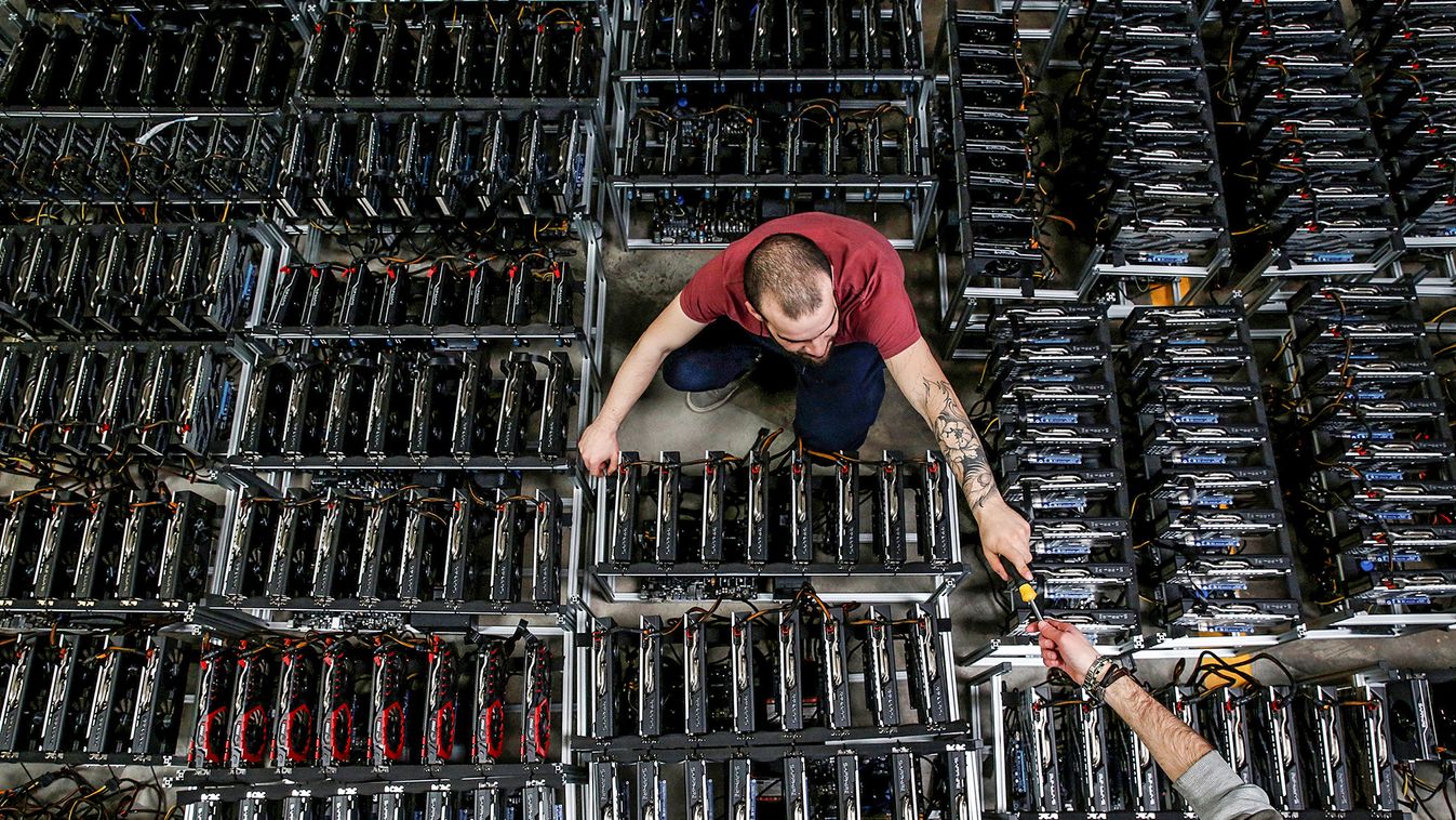 Employees work on bitcoin mining computers at Bitminer Factory in Florence