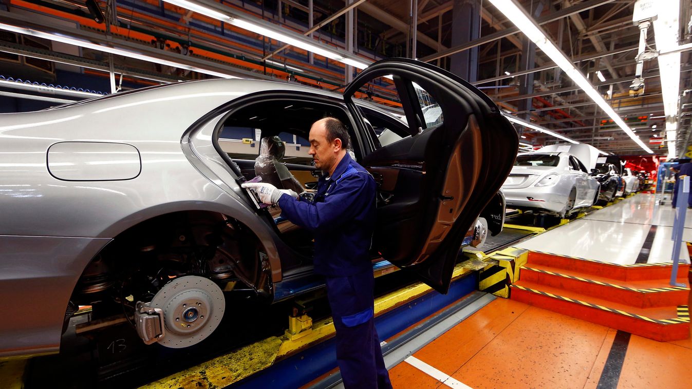 A worker assembles a Mercedes-Benz S-class model at their plant in Sindelfingen