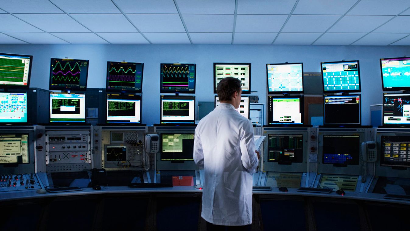 Scientist monitoring computers in control room