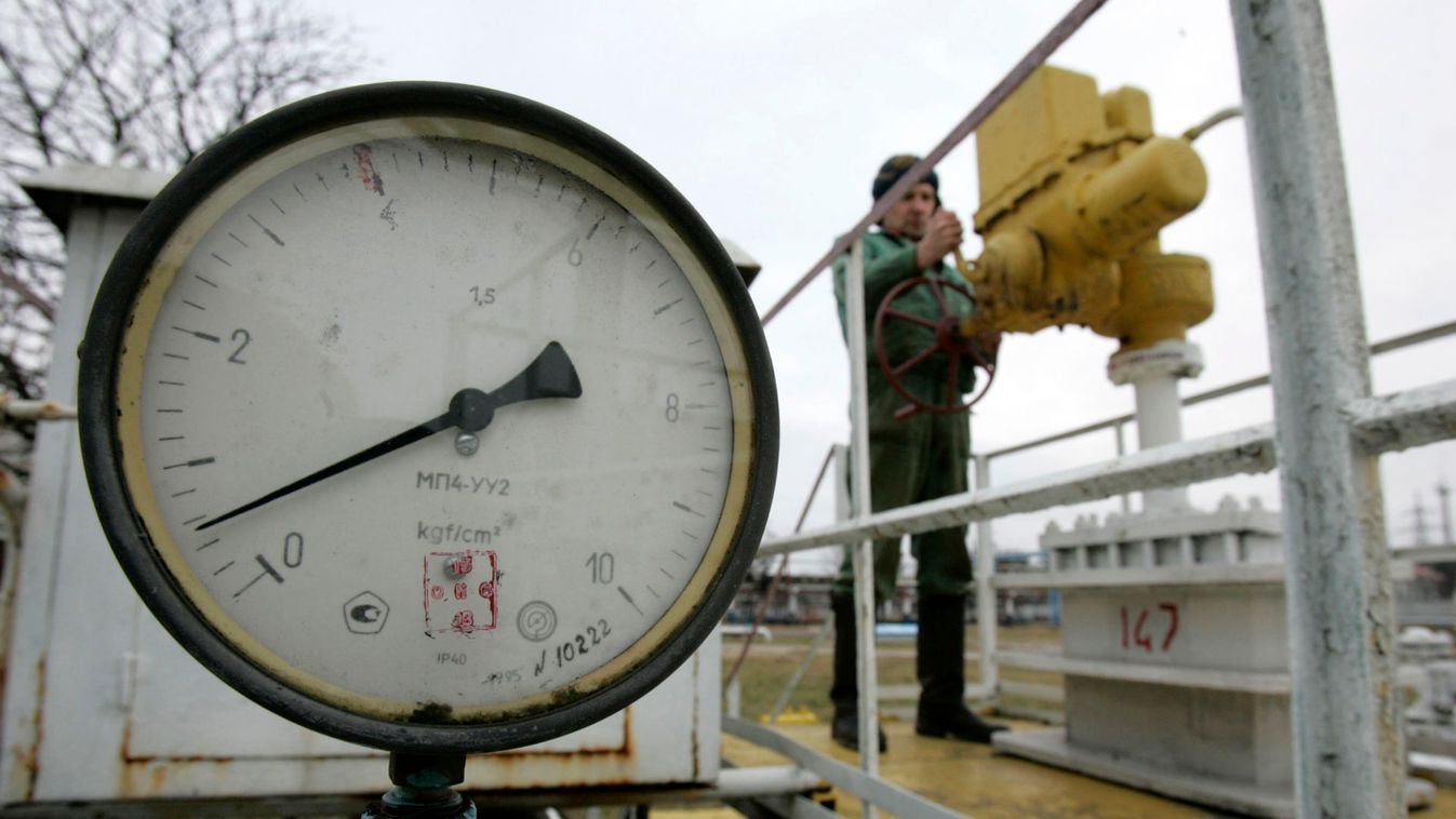 Worker turns tap as a meter shows near zero-level pressure at line production station on a Druzhba pipeline in Brody