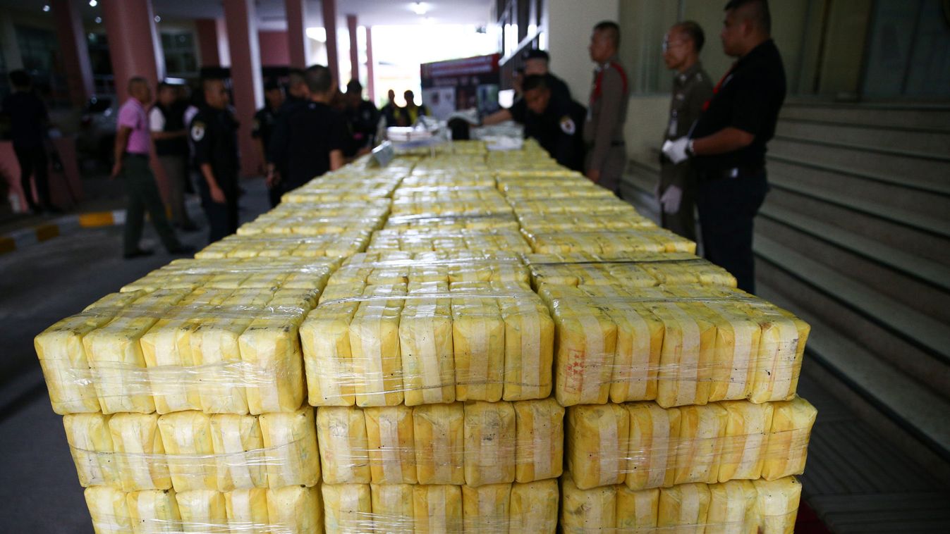 Police officers arrange seized drugs before a news conference at Office of the Narcotics Control Board in Bangkok