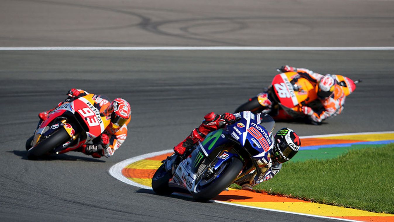 Yamaha MotoGP rider Lorenzo of Spain takes a curve ahead of compatriots and Honda riders Marquez and Pedrosa during the Valencia Motorcycle Grand Prix in Cheste, near Valencia