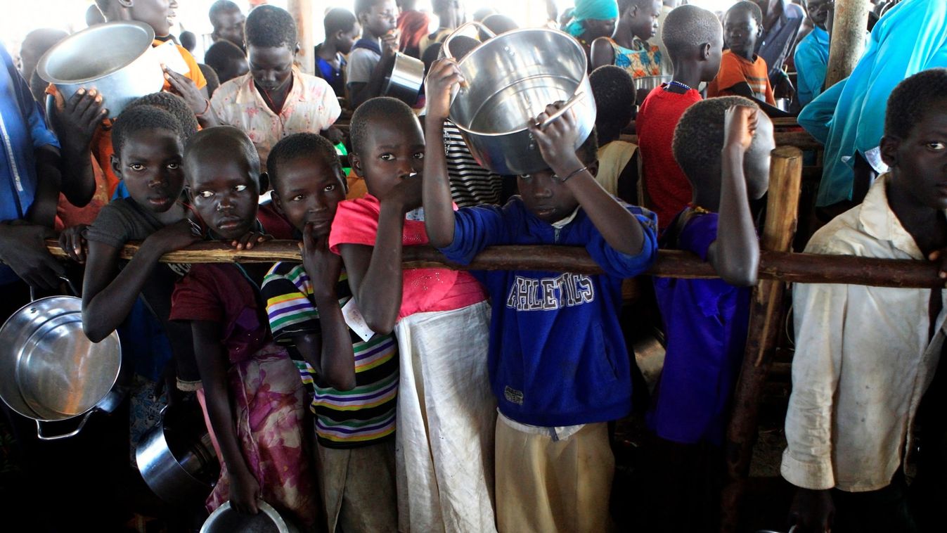 South Sudanese refugee children hold pots at Palabek Camp in Lamwo