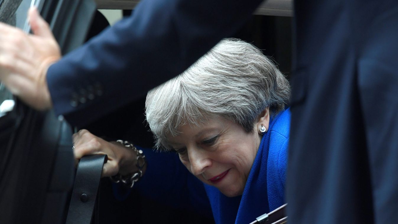 Britain's Prime Minister Theresa May climbs out of her car in Downing Street after returning from winning a Brexit vote in parliament in London