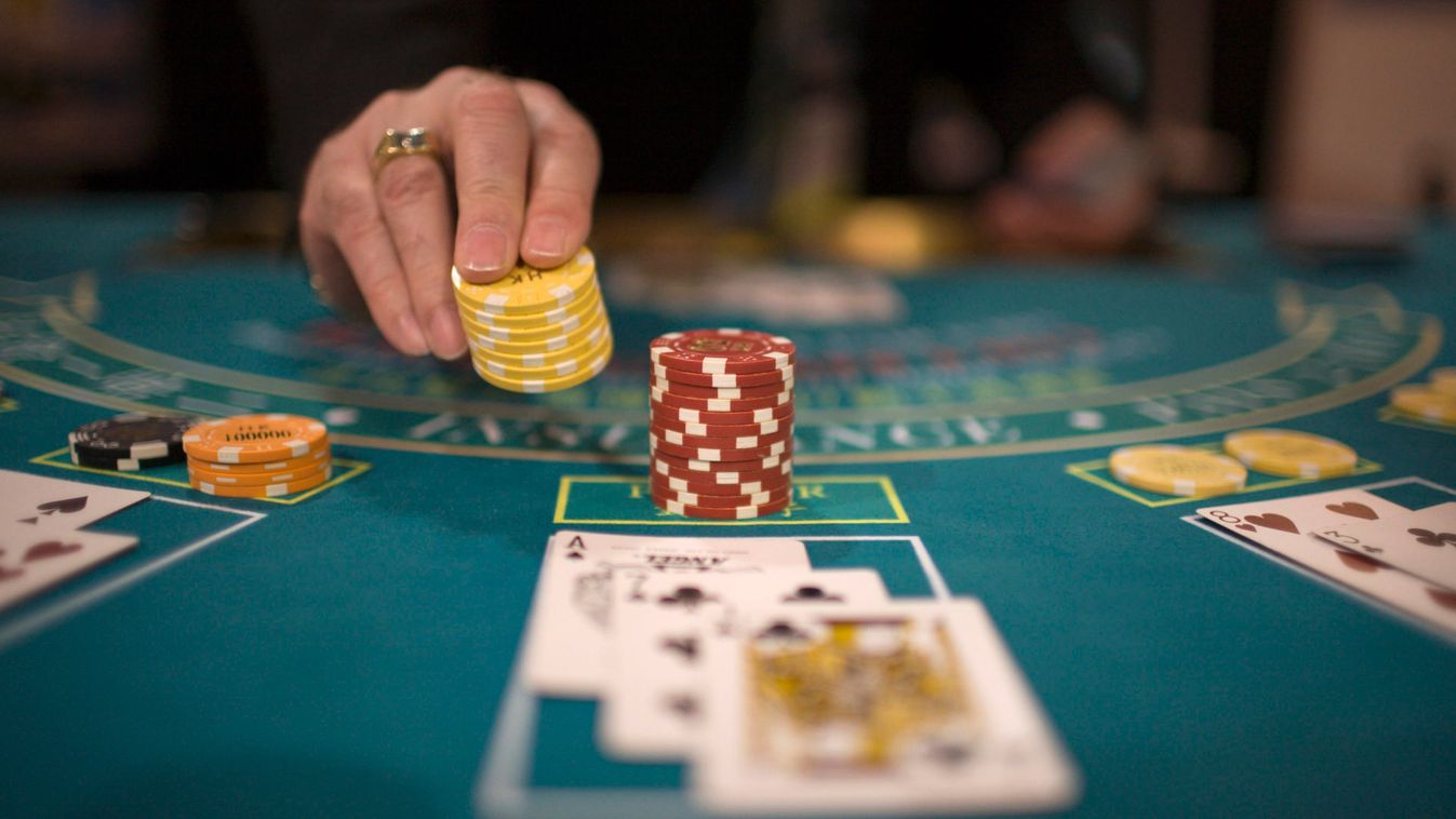 A croupier places casino chips during the Global Gaming Expo Asia in Macau