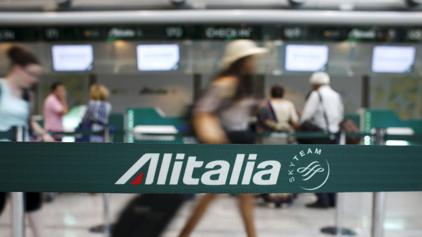 People walk in the Alitalia departure hall during a strike by Italy's national airline Alitalia workers at Fiumicino international airport in Rome