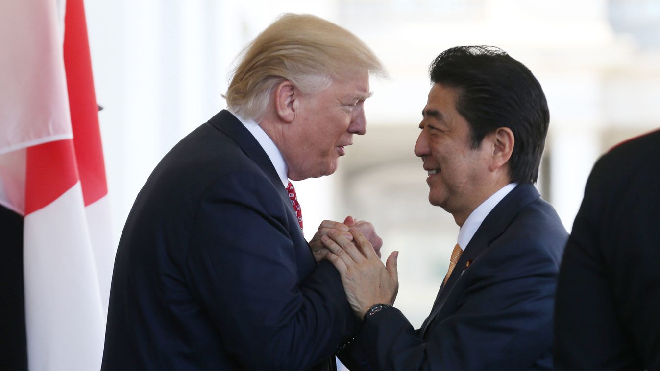 Japanese Prime Minister Abe is greeted by U.S. President Trump ahead of their joint news conference at the White House in Washington