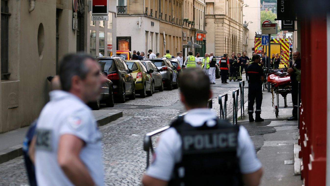 Police officers, fire fighters and medics are seen near the site of a suspected bomb attack in central Lyon