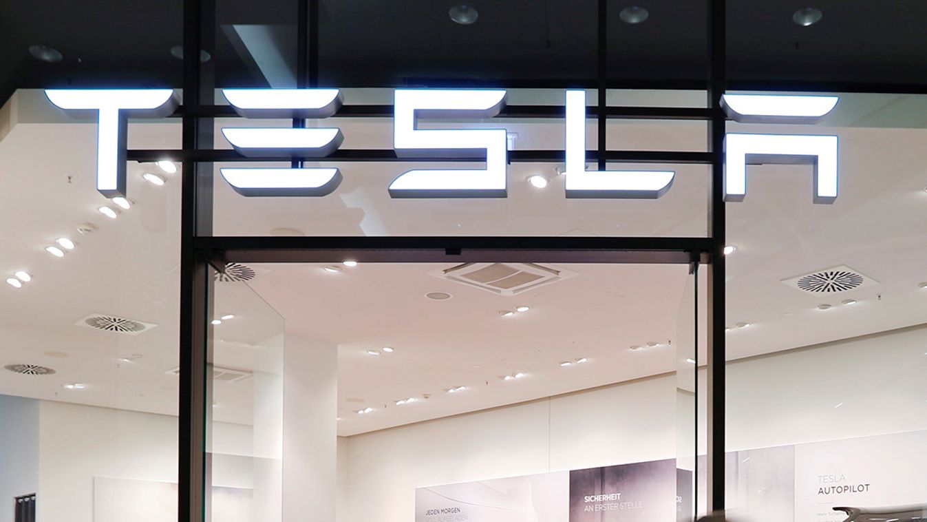 People walk past a flagstore shop of electric carmaker Tesla in Berlin