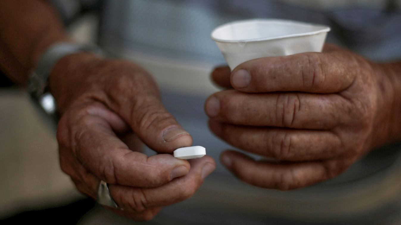 An elderly man holds his medication in Ciudad Juarez