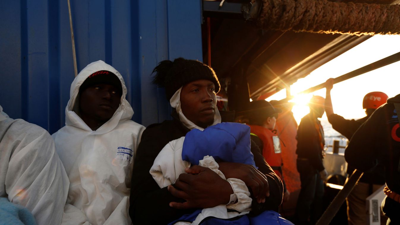 Rescued migrants rest on rescue ship 'Alan Kurdi' off the coast of Malta