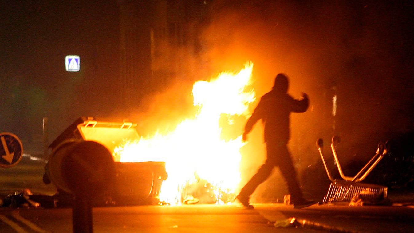 A car is set on fire by demonstrators at a street in Noerrebro