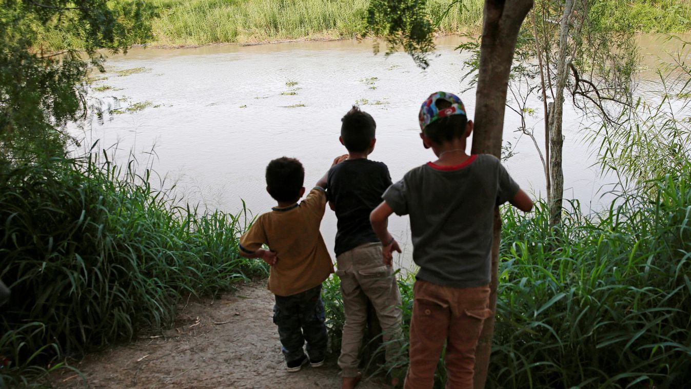Central American migrant children look at the Rio Bravo near the Brownsville-Matamoros International Bridge where they camp nearby, at the U.S.-Mexico border in Matamoros, Tamaulipas