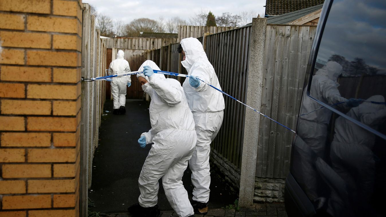 Forensic officers walk outside a property, which is being searched in connection with stabbing on London Bridge, in Stoke-on-Trent