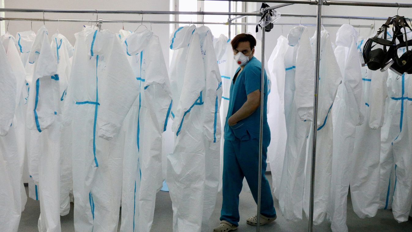 A medical specialist walks past personal protective equipment in a hospital in Moscow
