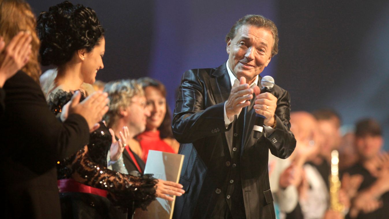 Czech legendary pop singer Karel Gott acknowledges ovations on a stage during a concert in Prague