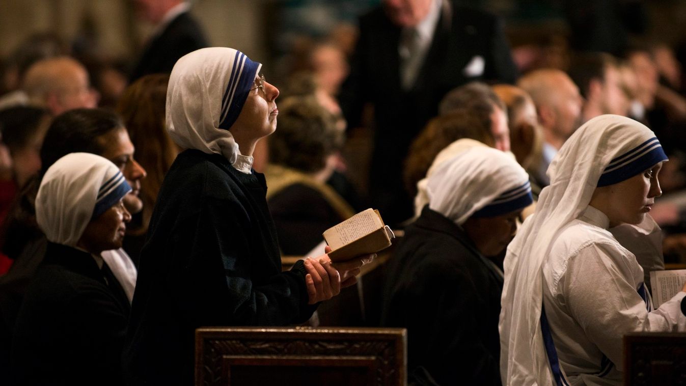 Catholic nuns pray during a a midnight Christmas mass at Saint Patrick's Cathedral in New York