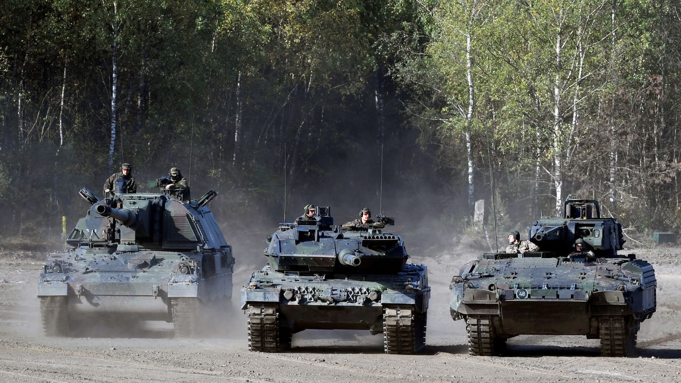A Panzerhaubitze 2000, a Leopard 2 tank and a PUMA infantry fighting vehicle (L-R) of German army Bundeswehr take part in an exercise during a media day in Munster,