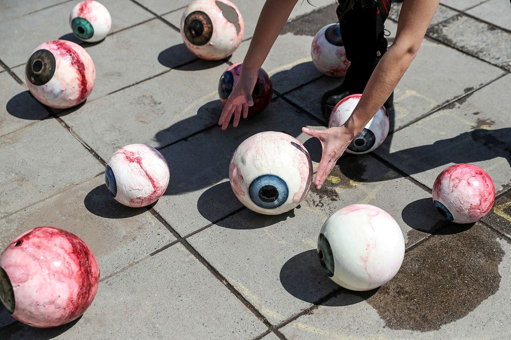 An activist places eye models as support to victims of ocular trauma during recent protests against Chile's government, ahead of the upcoming referendum on a new Chilean constitution in Santiago