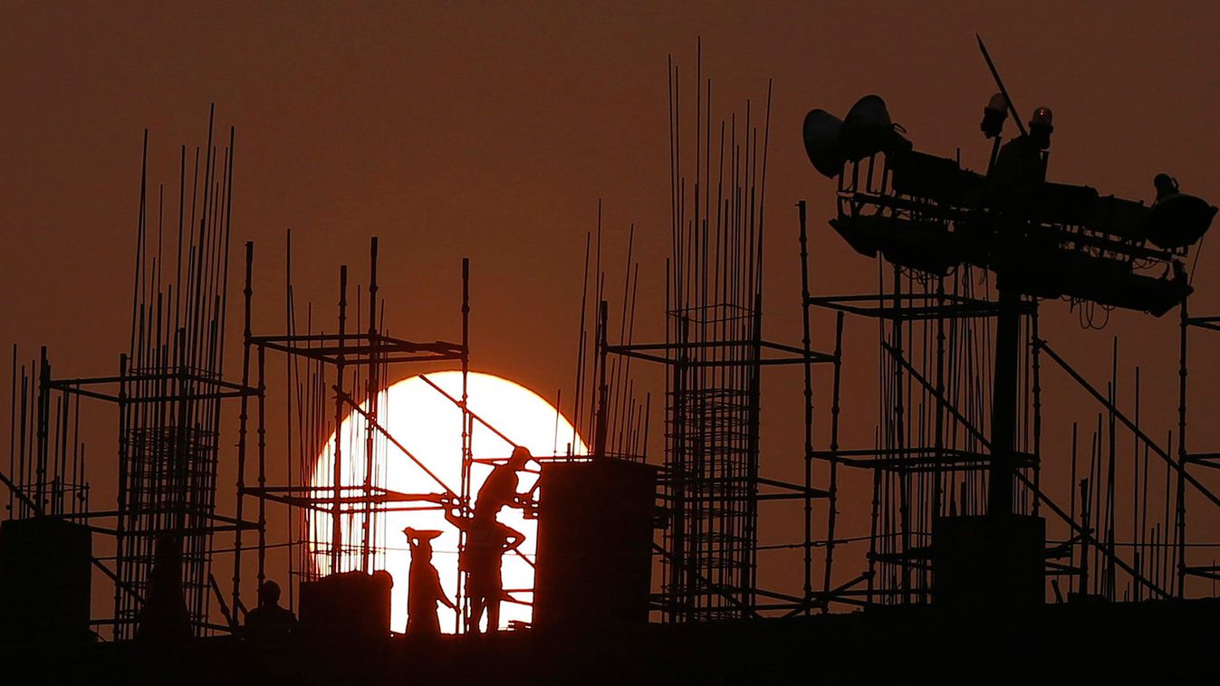Labourers work at the site of a government hospital building under construction in New Delhi