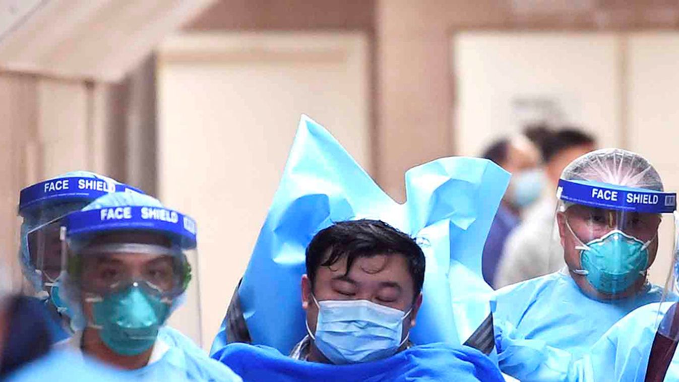 Medical staff transfer a patient of a highly suspected case of a new coronavirus at the Queen Elizabeth Hospital in Hong Kong
