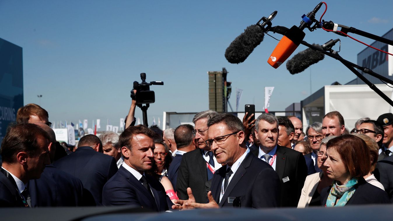 French President Emmanuel Macron talks with Eric Beranger, CEO of MBDA missile Systems, during a visit at the 53rd International Paris Air Show at Le Bourget Airport