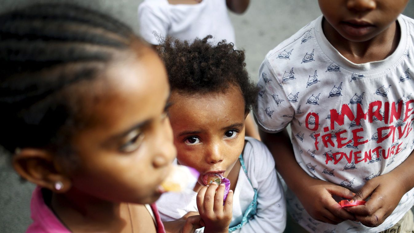 Children gather outside the migration centre next to the Tiburtina train station in Rome