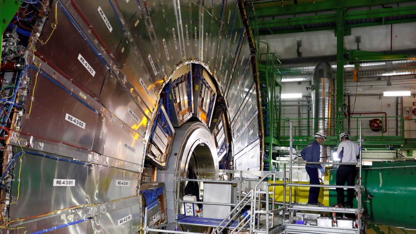 Technicians are seen working in the CMS experiment during a media visit to CERN in Cessy