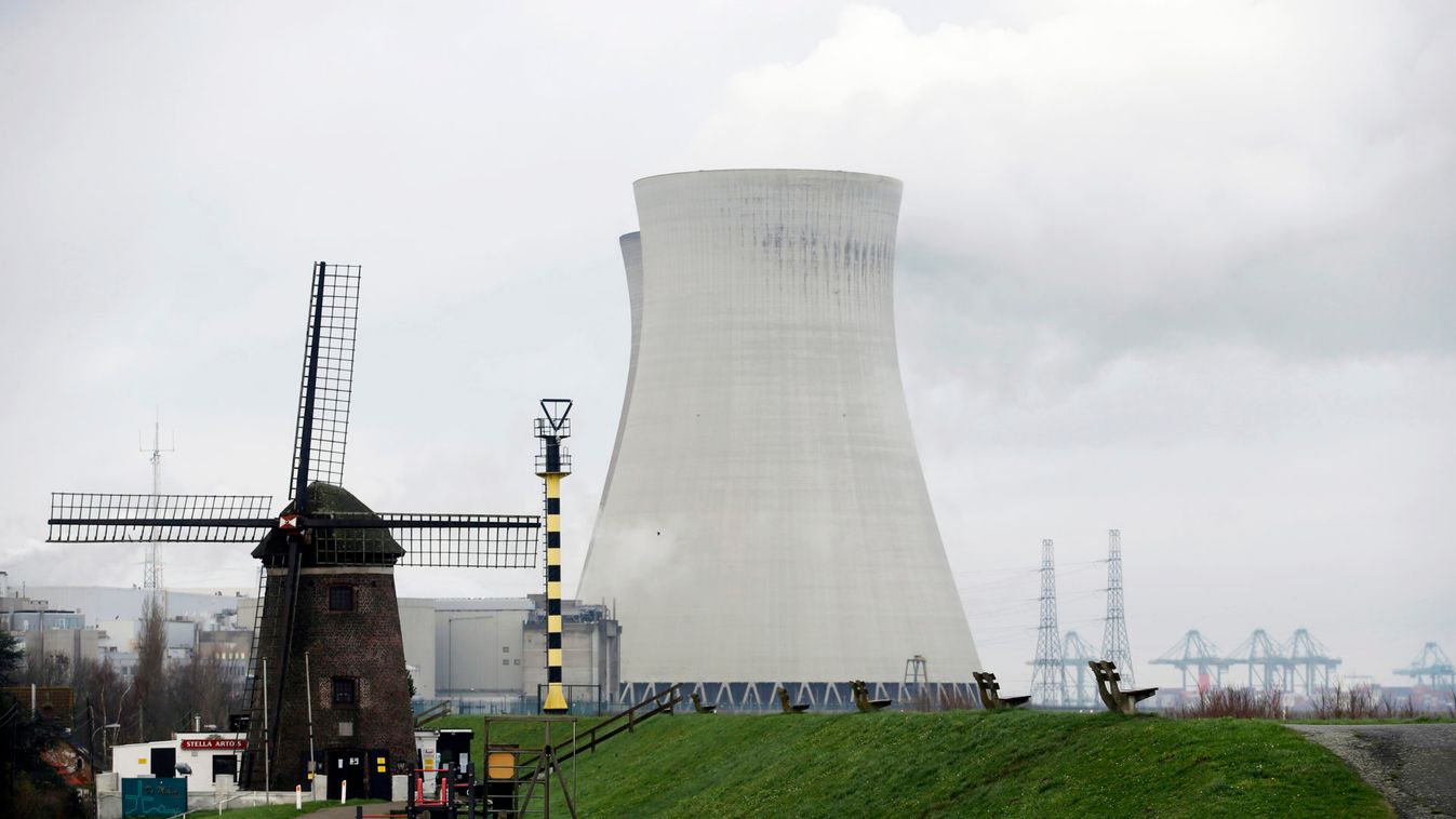 A windmill is pictured near the cooling towers of the Doel nuclear plant of Electrabel in Doel near Antwerp