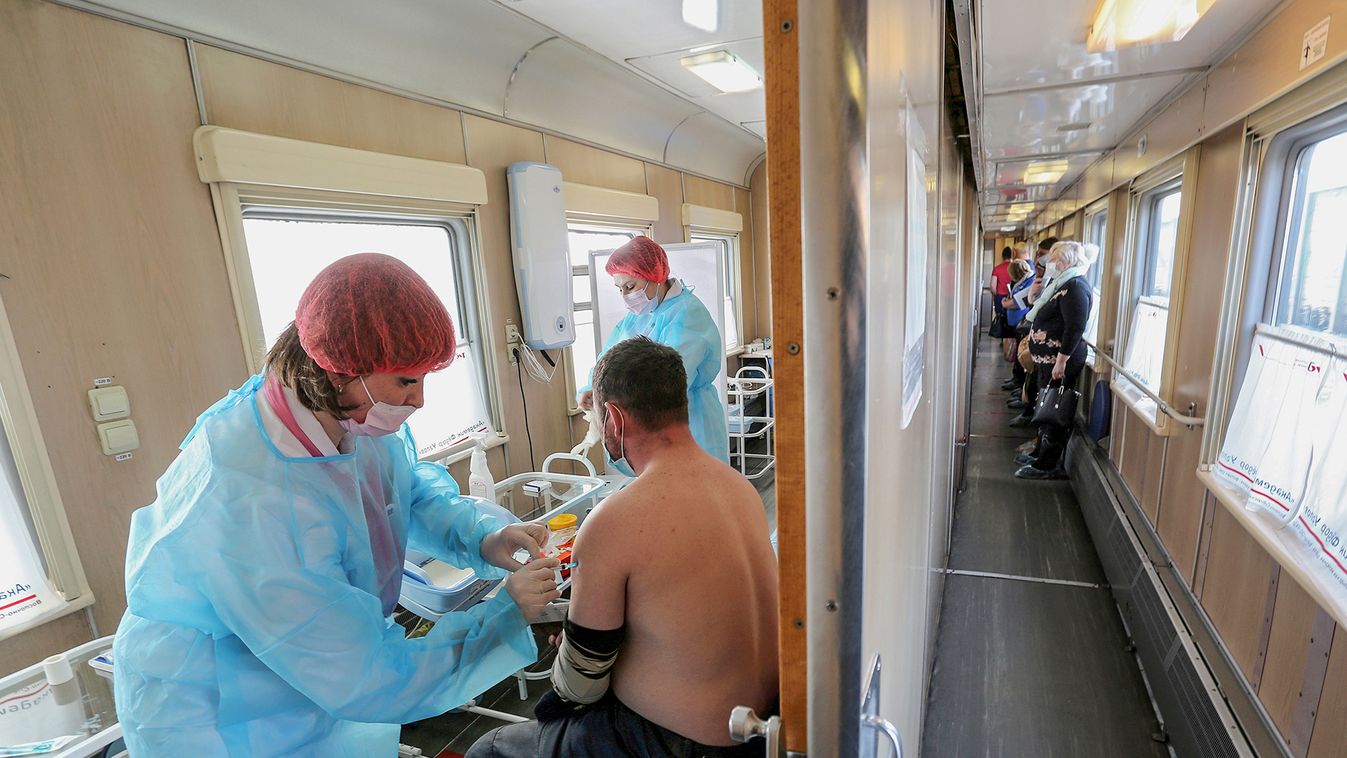A man receives a dose of COVID-19 vaccine in a medical train in Tulun
