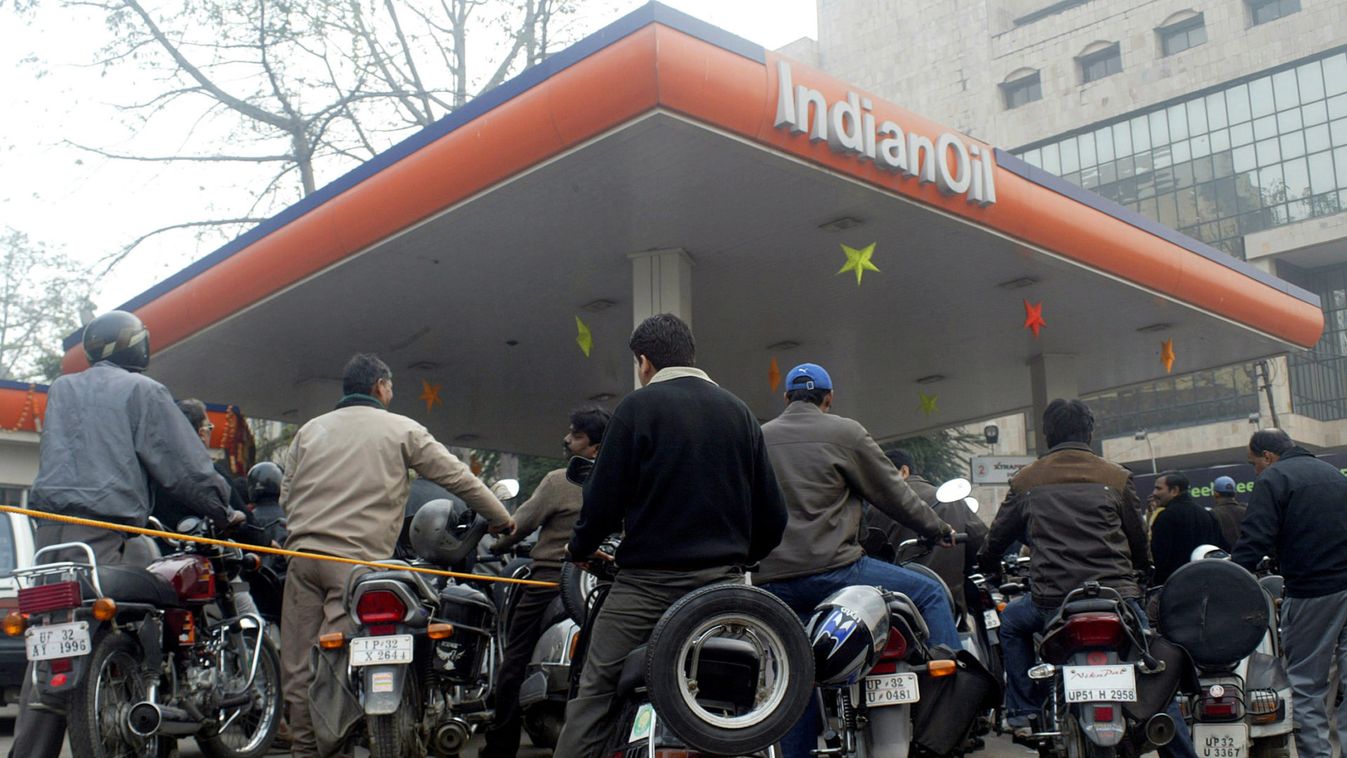Motorists wait for their turn to fill petrol at a gas station in Lucknow