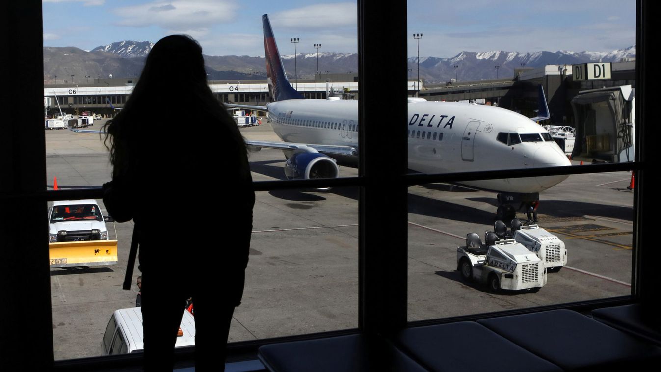 A woman waits for a flight  at Salt Lake City International Airport in Salt Lake City