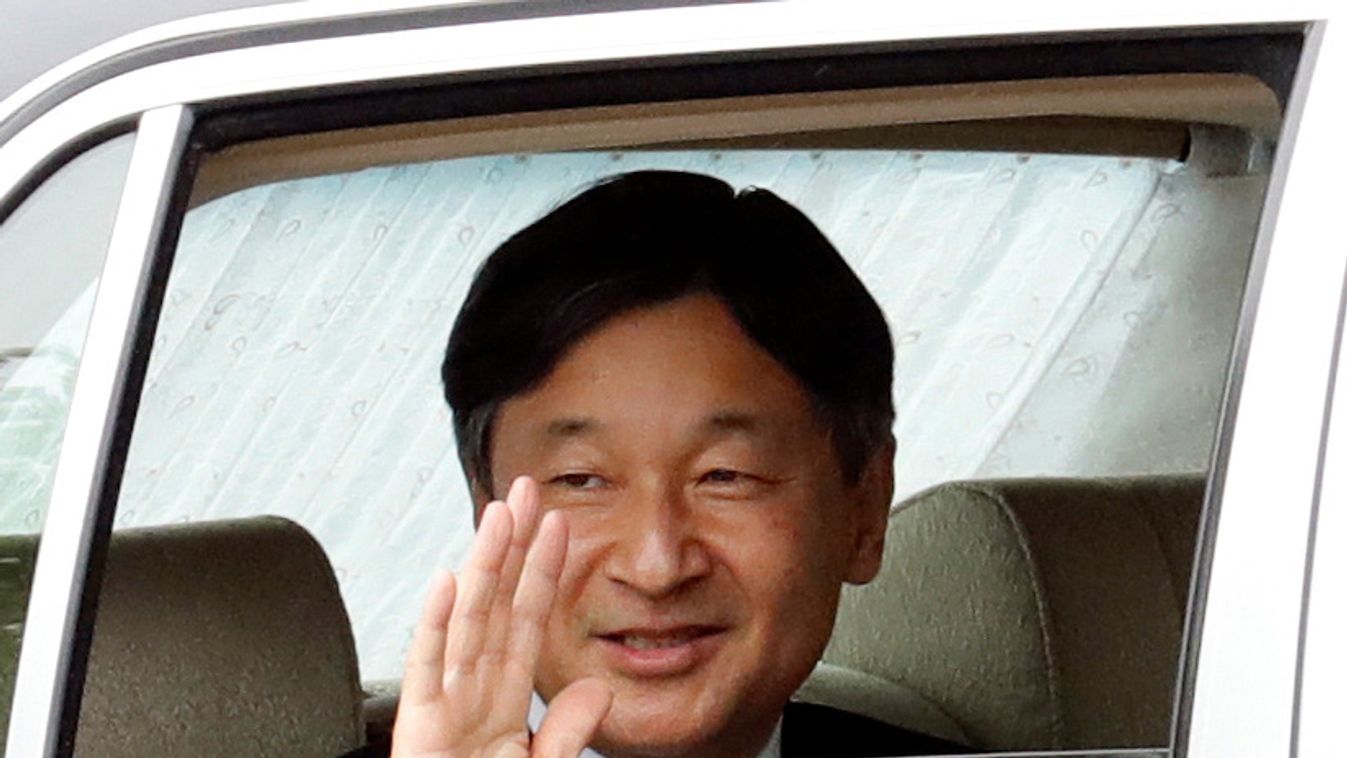 Japan's new Emperor Naruhito waves as he arrives at the Imperial Palace in Tokyo
