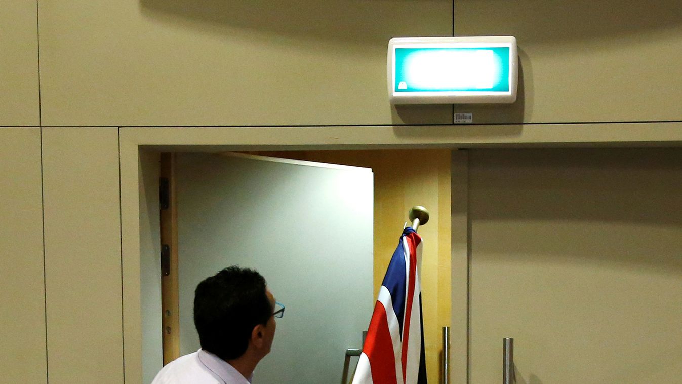 An official carries a Union Jack flag ahead of a news conference by Britain's Secretary of State for Exiting the European Union Davis and EU's chief Brexit negotiator Barnier in Brussels