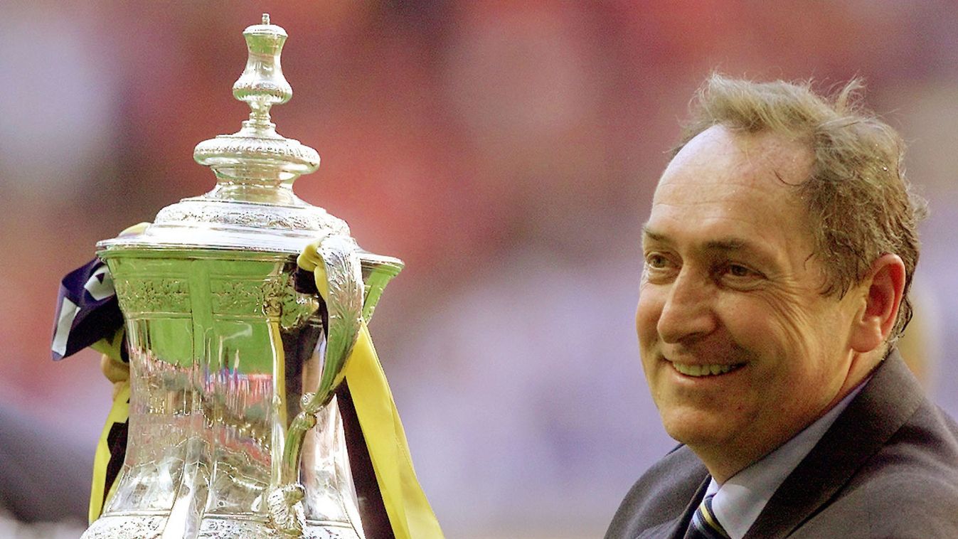 LIVERPOOL MANAGER GERARD HOULLIER HOLDS ALOFT THE FA CUP IN CARDIFF.