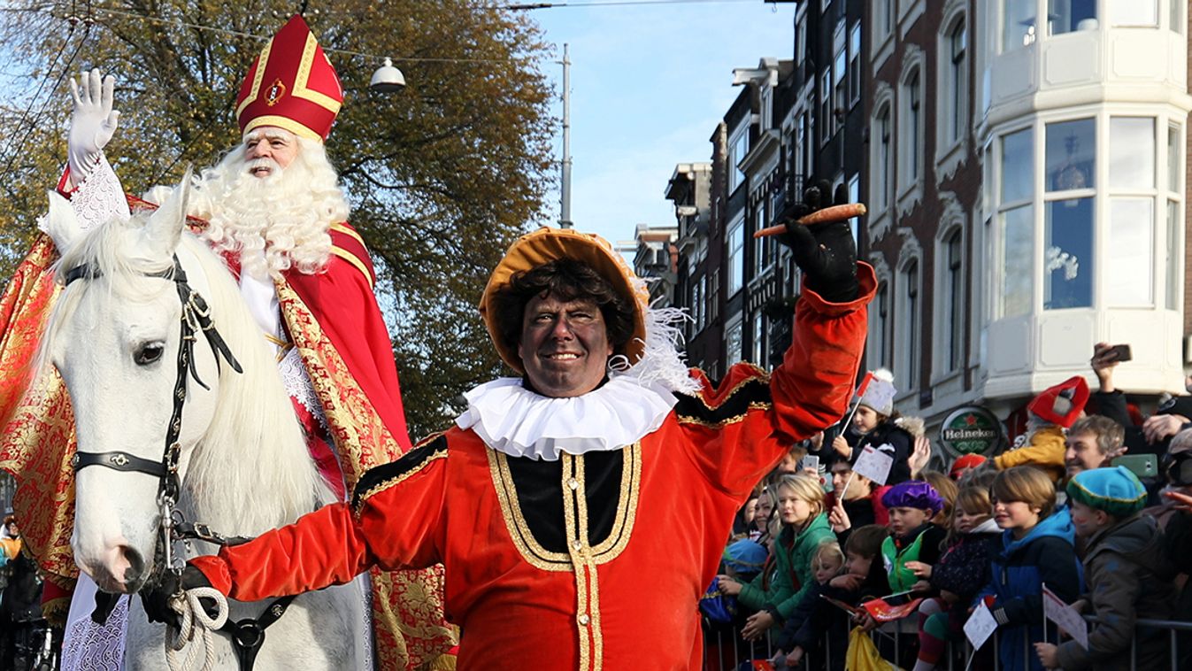 Saint Nicholas is escorted by his assistants called "Zwarte Piet" (Black Pete) during a traditional parade in Amsterdam