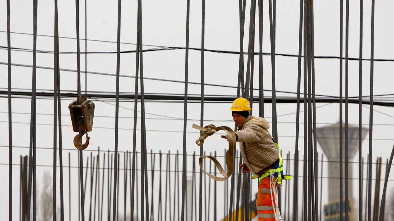 A labourer works at a bridge construction site in Bucharest