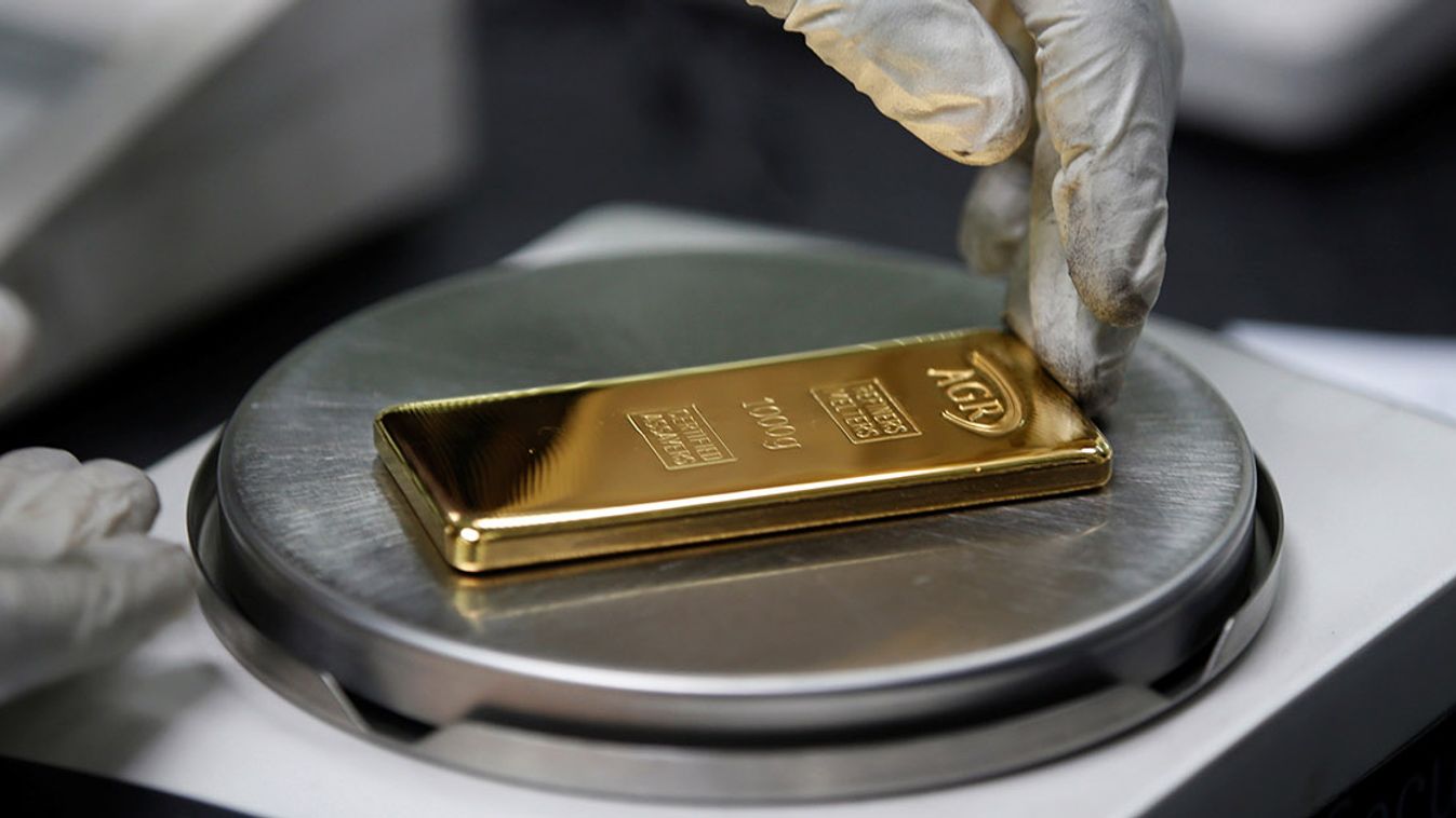 An employee weighs a 1kg gold bar at AGR (African Gold Refinery) in Entebbe