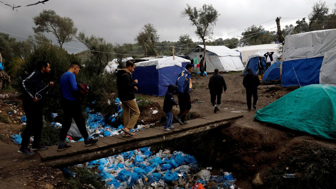 Migrants make their way at a makeshift camp next to the Moria camp, on the island of Lesbos