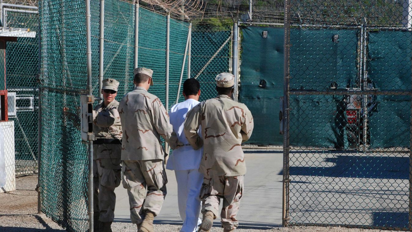 File photo of US Navy guards escorting a detainee through Camp Delta at Guantanamo Bay naval base