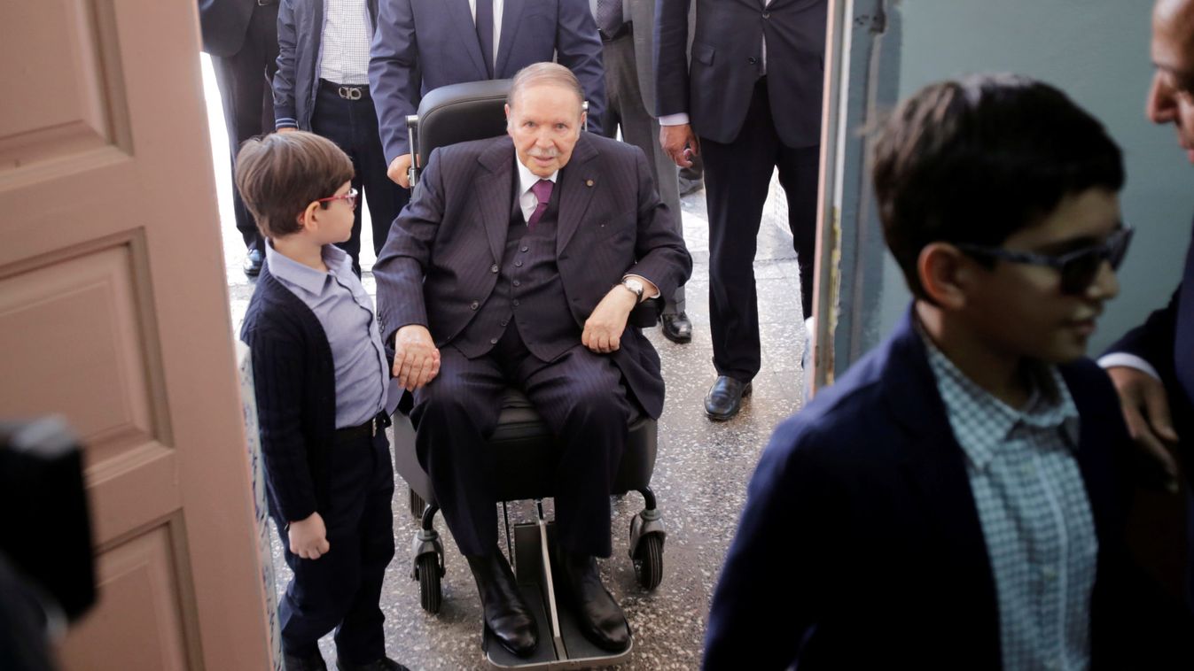 Algeria's President Abdelaziz Bouteflika arrives with his nephew to cast his ballot during the parliamentary election in Algiers