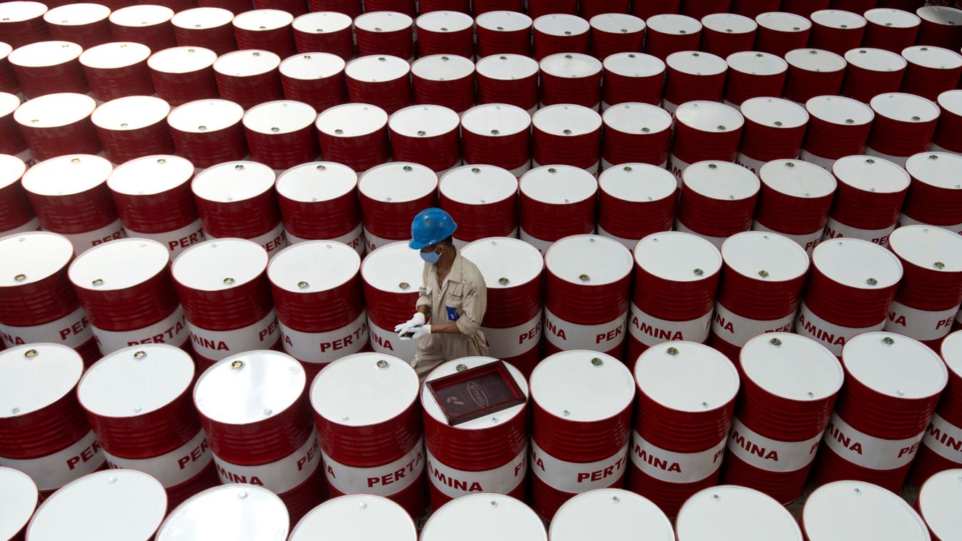 A worker prepares to label barrels of lubricant oil at the state oil company Pertamina's lubricant production facility in Cilacap, Central Java