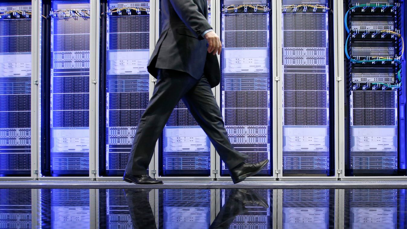 An employee of Rittal IT poses for the media in front of servers during preparations at the CeBit computer fair in Hanover