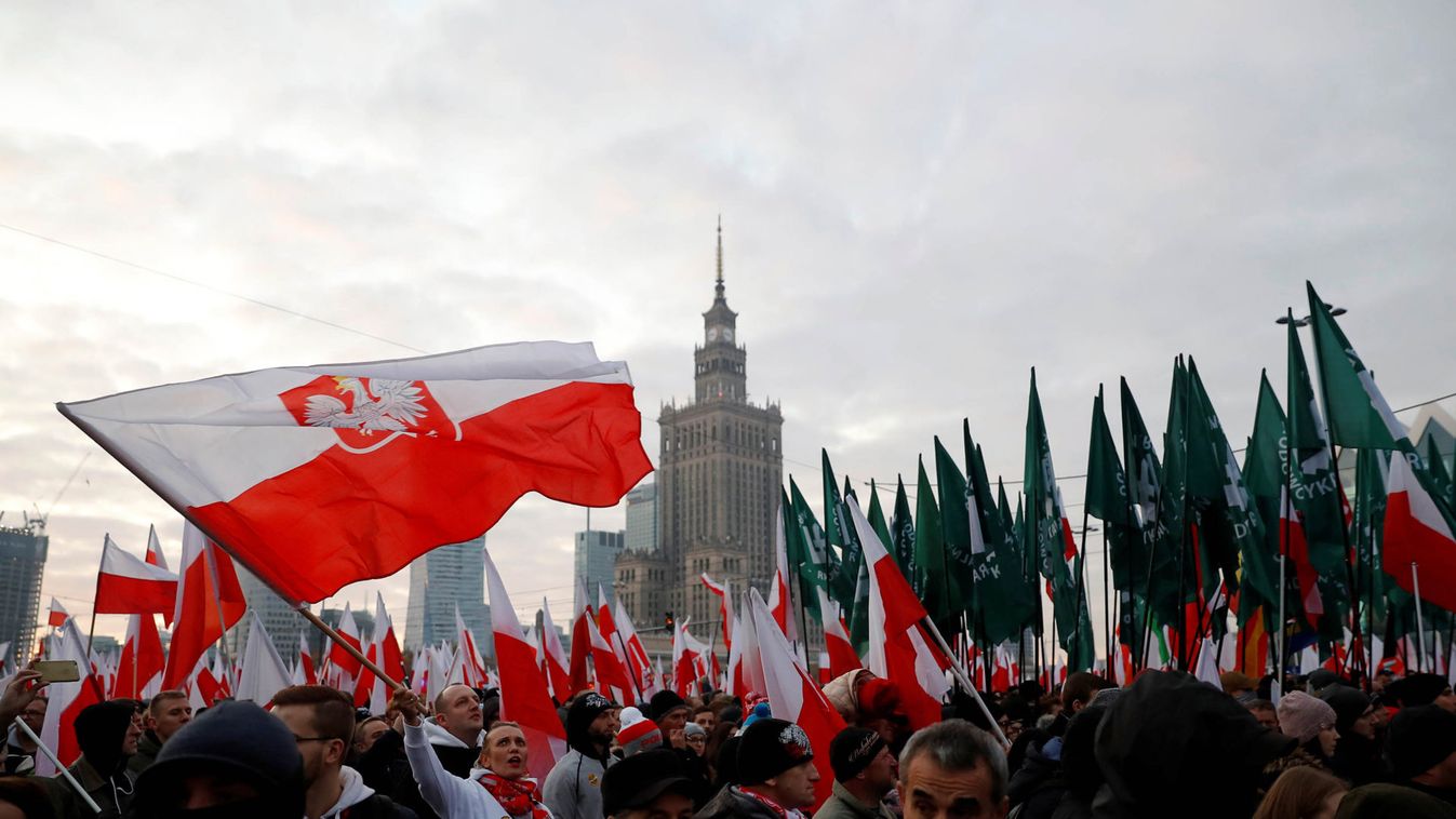 People hold flags during a march marking the 101st anniversary of Polish independence in Warsaw