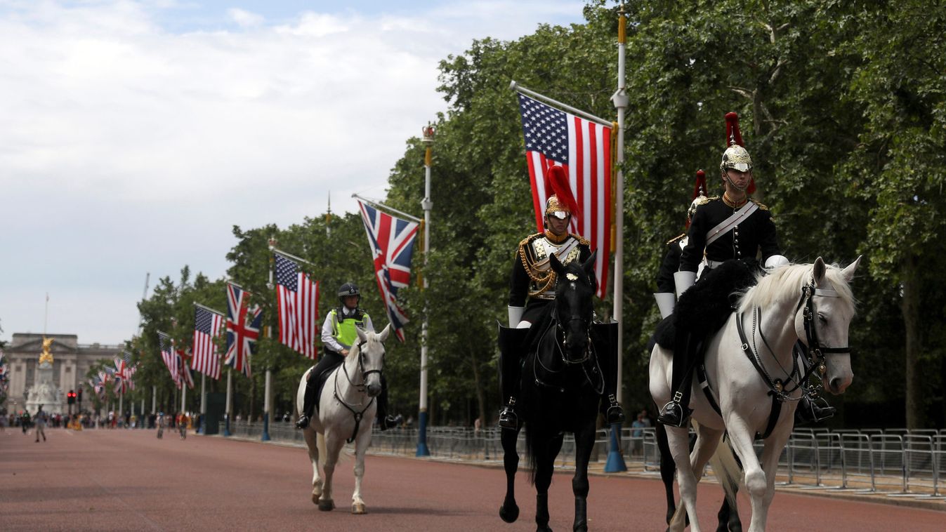 Police officers and Guardsman from the Horse Guards move past U.S. and British flags as they stretch along The Mall towards Buckingham Palace in central London in advance of U.S. President Donald Trump State visit to Britain