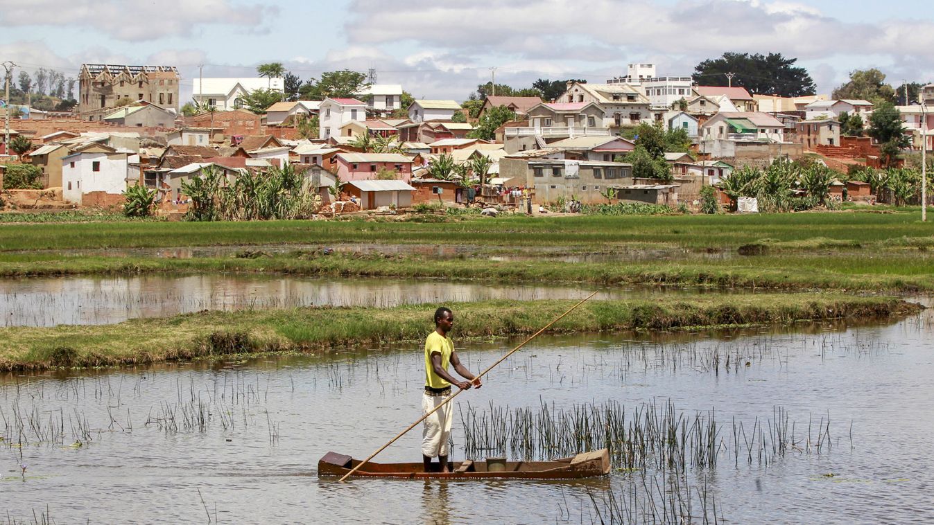 File photo shows a man travelling in a boat to fish in a pond in the outskirts of the capital Antananarivo