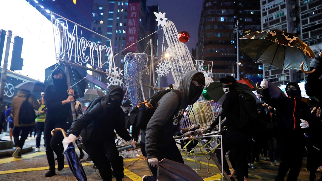 Anti-government protesters tear down Christmas and New Year's decorations during a demonstration on New Year's Eve outside Mong Kok police station in Hong Kong