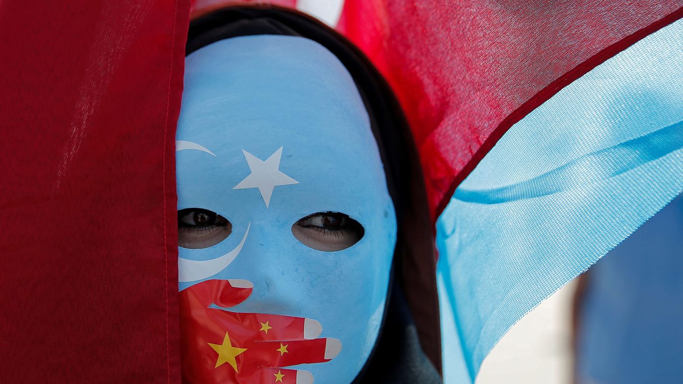 An ethnic Uighur demonstrator wears a mask as she attends a protest against China in front of the Chinese Consulate in Istanbul